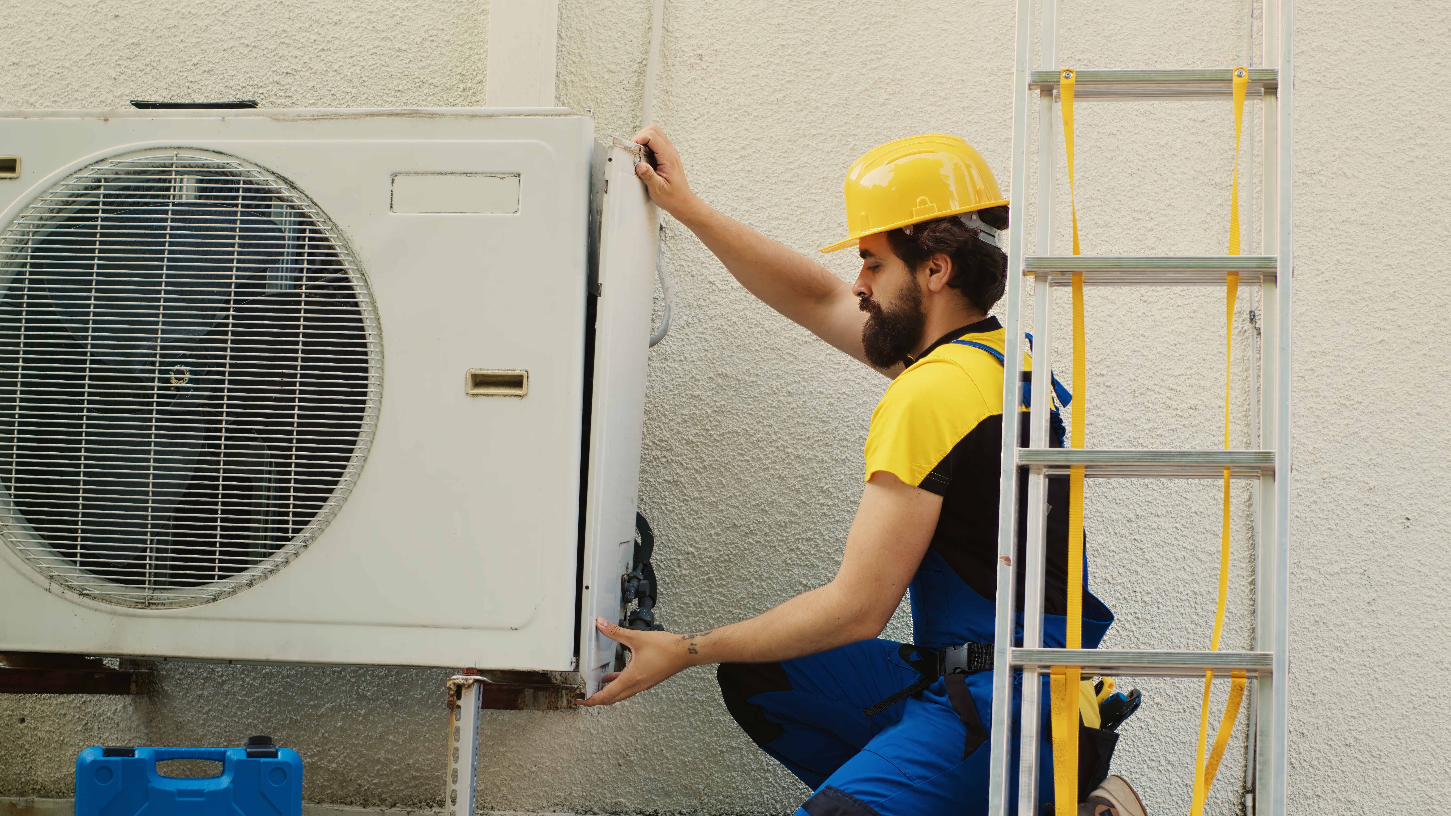 AC technician servicing outdoor unit